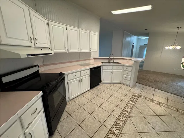a kitchen with a sink and cabinets