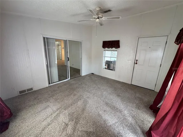 a view of empty room with a fireplace