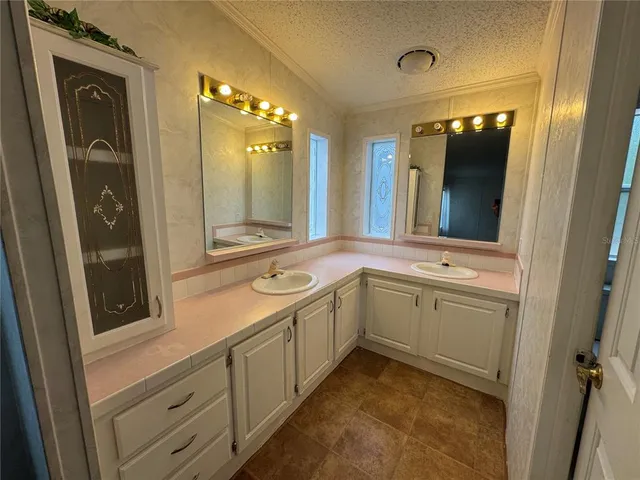 a bathroom with a granite countertop sink mirror and bathtub