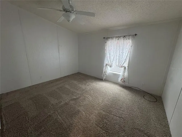 an empty room with a empty space and windows