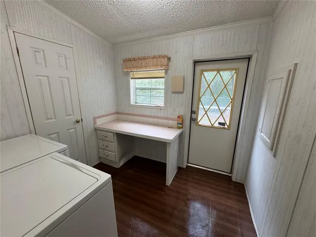 a room that has a wooden floor and a table in it