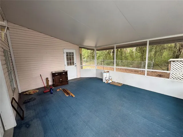 a view of a room with gym equipment and windows