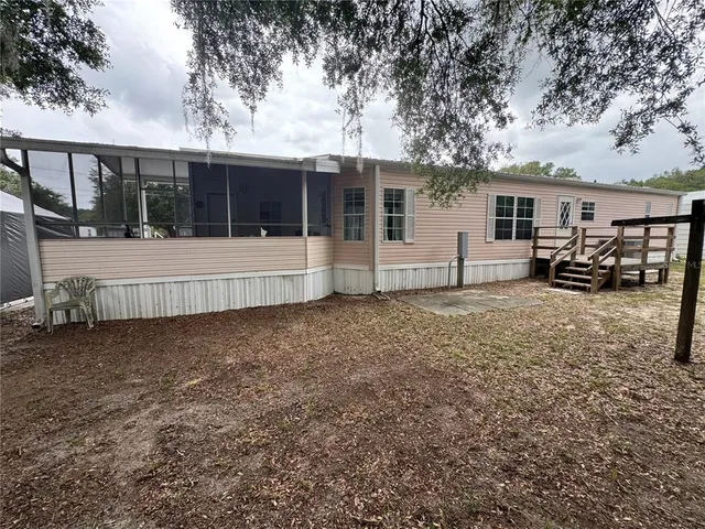 a view of a house with a yard and sitting area