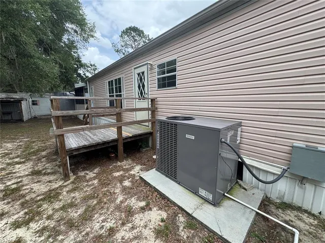 a view of a house with a chairs in patio