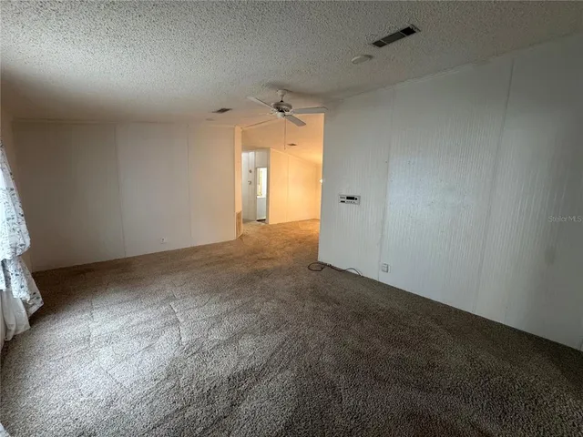 a view of a big room with closet and windows