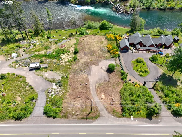 an aerial view of a house with a yard and lake view