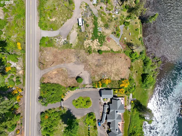 an aerial view of a house with a yard and garden