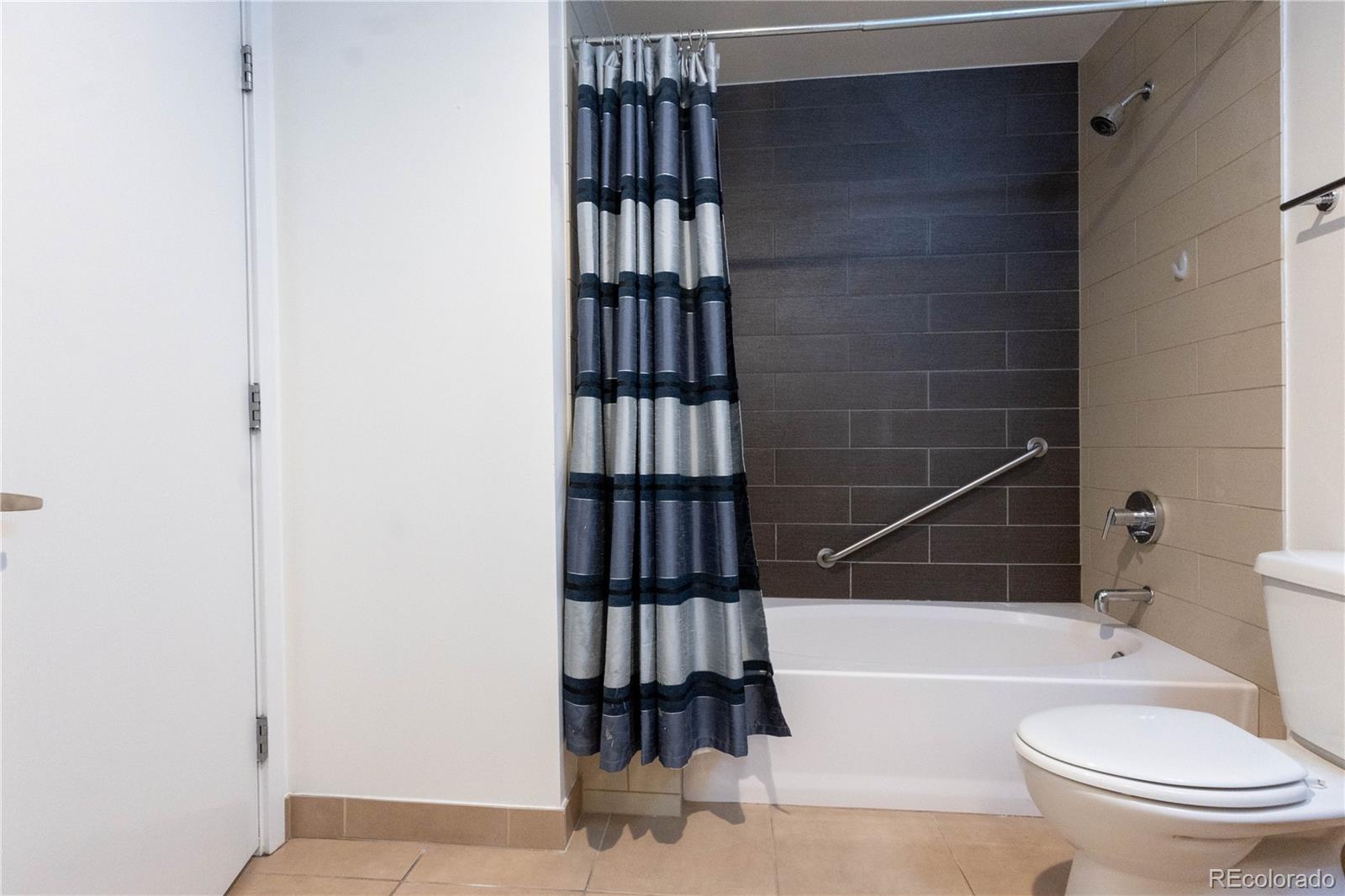 891 14th Street, Unit 2105 Denver, CO 80202 - Photo 23 of 50 a bathroom with a toilet a bathtub and a shower