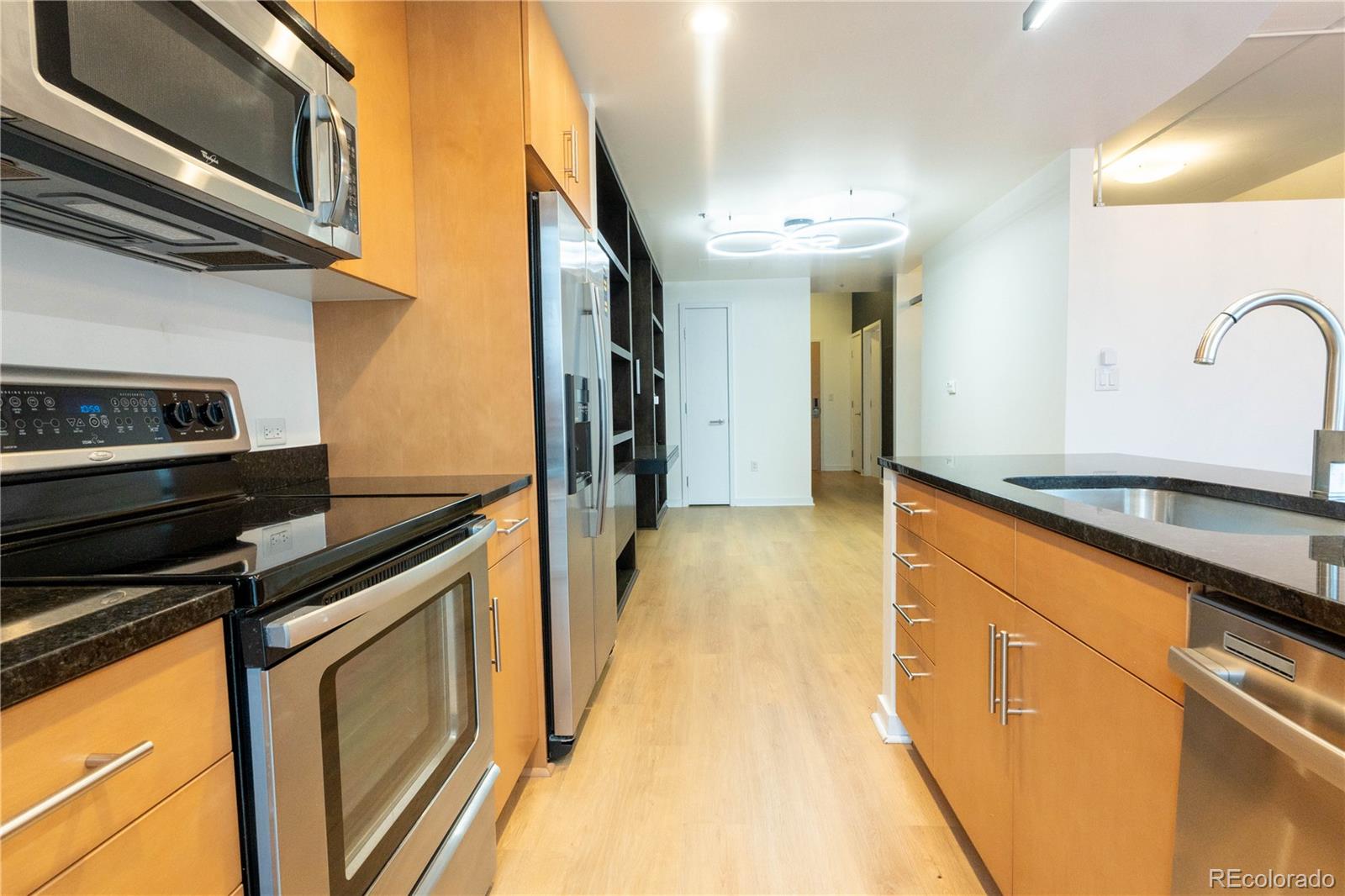 891 14th Street, Unit 2105 Denver, CO 80202 - Photo 27 of 50 a kitchen with stainless steel appliances granite countertop a sink and a stove