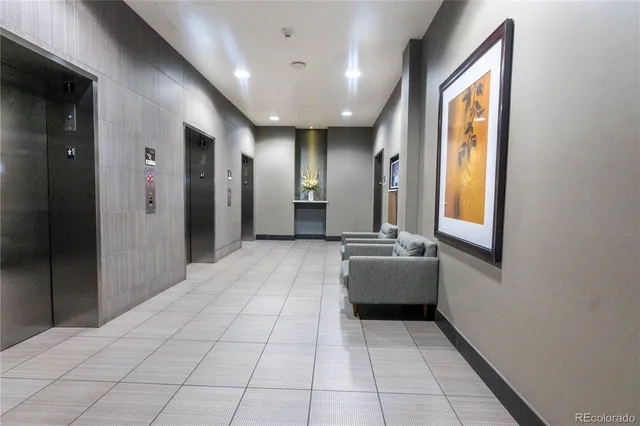 a lobby with furniture and large windows