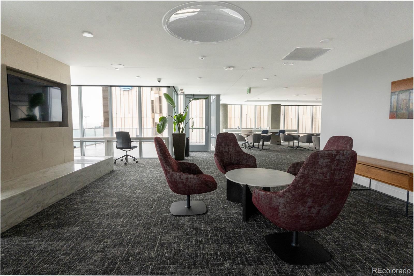891 14th Street, Unit 2105 Denver, CO 80202 - Photo 33 of 50 a living room with furniture a flat screen tv and a large window