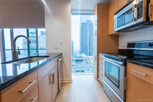 a kitchen with granite countertop a stove top oven
