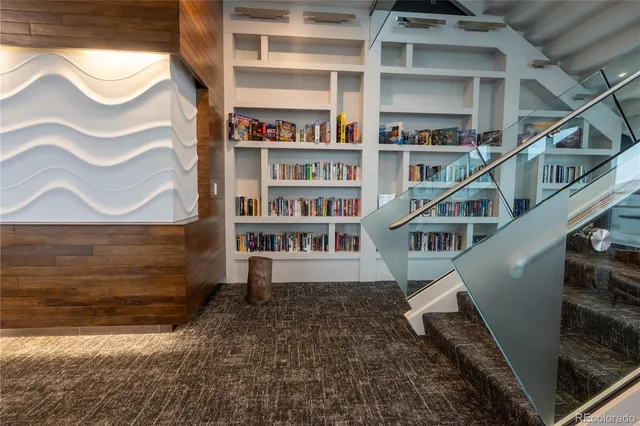 a lobby with furniture and large windows