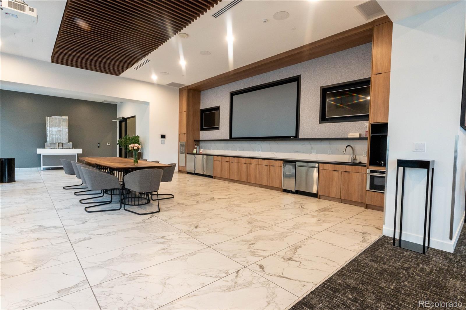 891 14th Street, Unit 2105 Denver, CO 80202 - Photo 44 of 50 a living room with furniture a flat screen tv and white walls