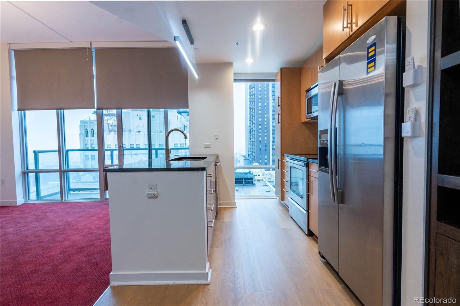 891 14th Street, Unit 2105 Denver, CO 80202 - Photo 8 of 50 a view of a hallway with wooden floor and staircase