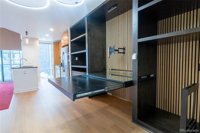 a view of a living room hardwood floor and a kitchen
