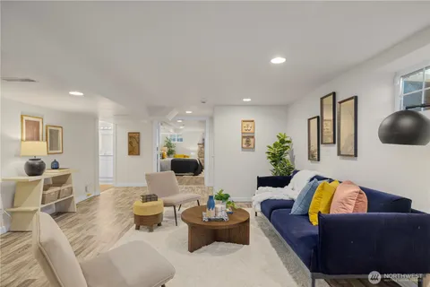 a living room with furniture and wooden floor