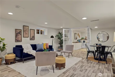 a living room with furniture a dining table and a potted plant