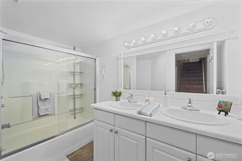 a bathroom with a sink double vanity and a bathtub