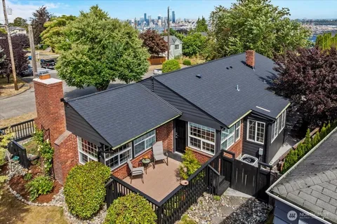 an aerial view of a house roof deck and outdoor seating