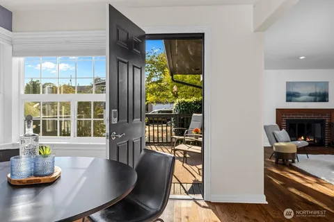 a dining room with furniture and a floor to ceiling window