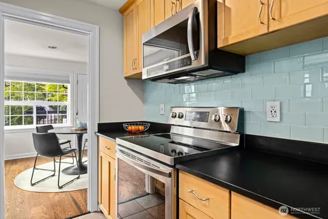 a kitchen with stainless steel appliances granite countertop a sink and a stove