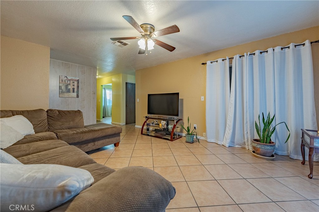 2394 Lance Street Merced, CA 95348 - Photo 16 of 34 a living room with furniture and a flat screen tv