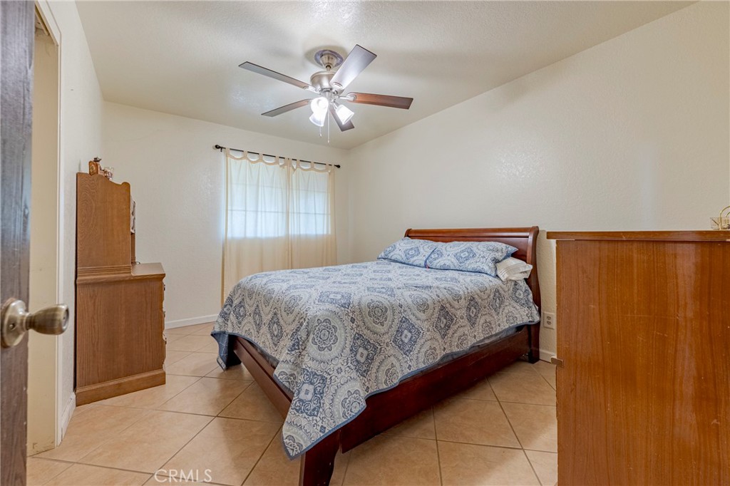 2394 Lance Street Merced, CA 95348 - Photo 18 of 34 a bedroom with a bed and a chandelier