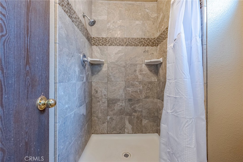 2394 Lance Street Merced, CA 95348 - Photo 28 of 34 a bathroom with a granite countertop shower and a sink