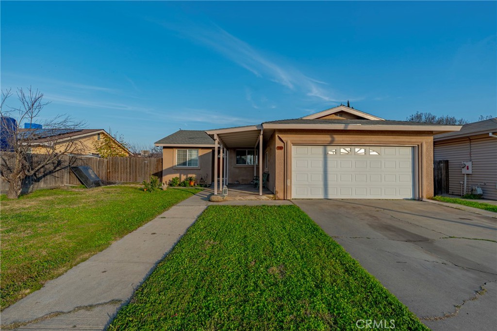 2394 Lance Street Merced, CA 95348 - Photo 5 of 34 a front view of a house with a garden and yard