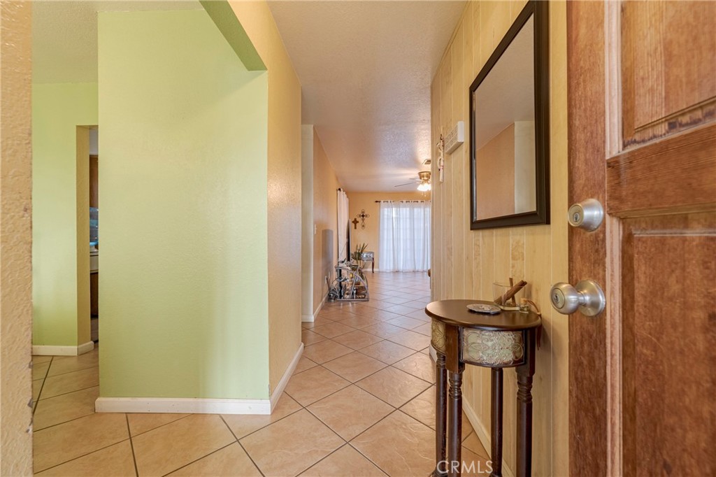 2394 Lance Street Merced, CA 95348 - Photo 6 of 34 a view of a hallway with dining area and chandelier