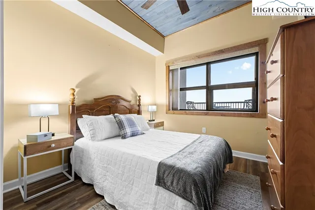 a bedroom with a bed and a lamp