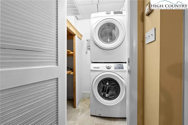 a kitchen with kitchen island a counter top space a sink stainless steel appliances and cabinets