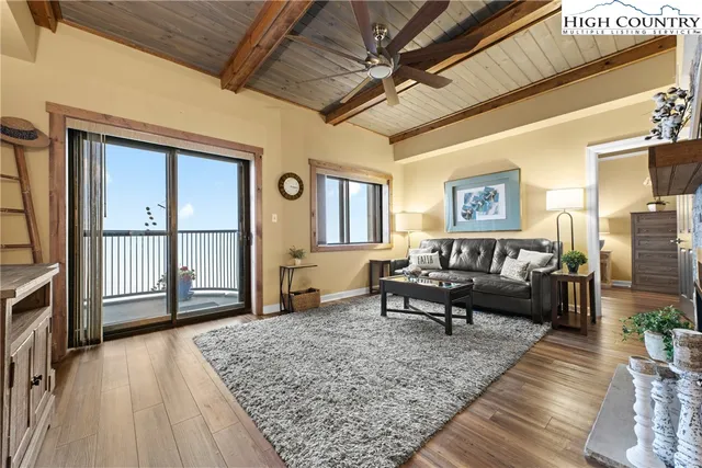 a view of a balcony with furniture and a potted plant
