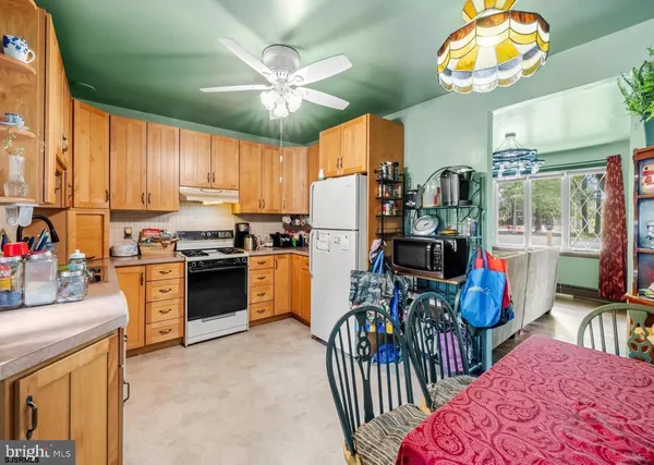 a kitchen with stainless steel appliances kitchen island granite countertop a refrigerator a stove top oven a sink and dishwasher