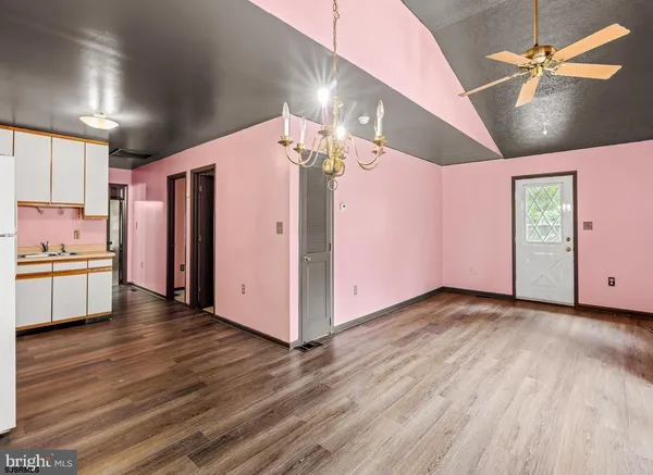 a view of a kitchen with a refrigerator and a stove top oven