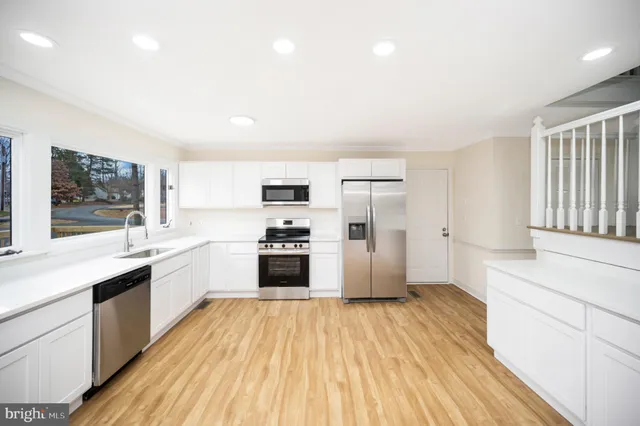 a kitchen with stainless steel appliances a refrigerator stove and microwave