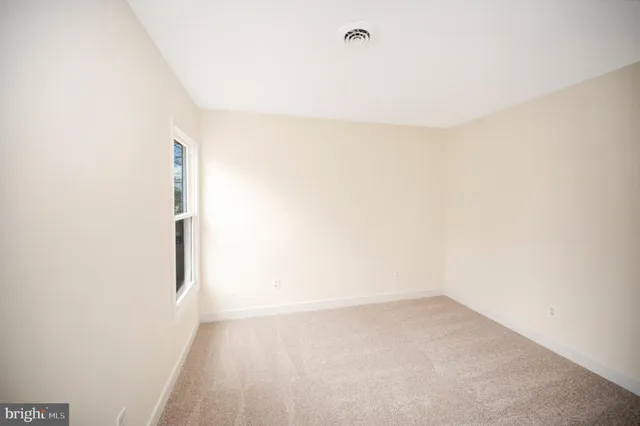 a view of staircase with wooden floor and white walls