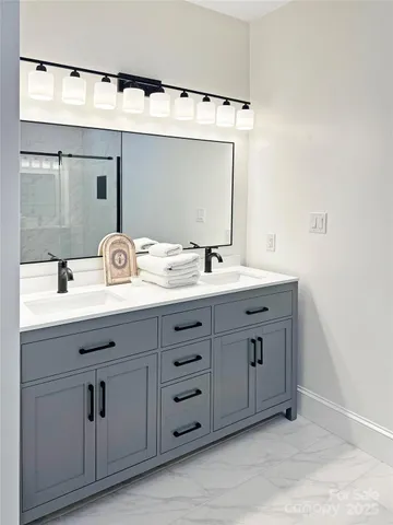 a bathroom with a double vanity sink and mirror