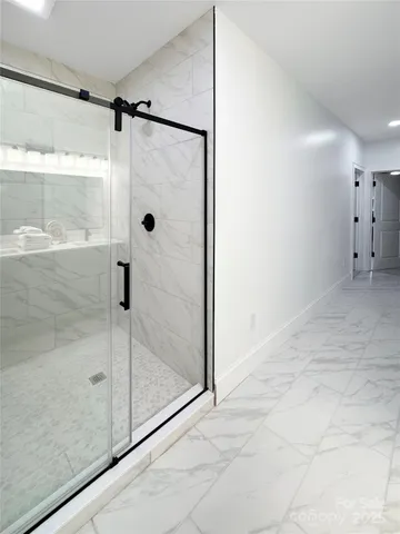 a bathroom with a glass shower door