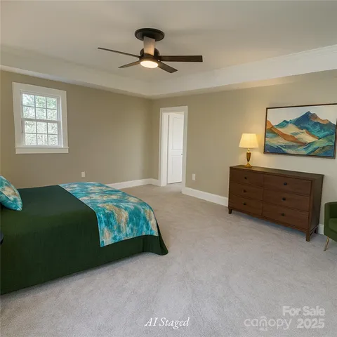 a bedroom with a bed and a painting on the wall