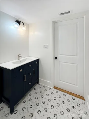 a bathroom with a sink vanity and mirror