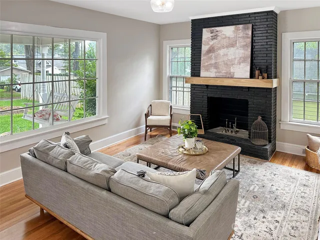 a living room with furniture and a fireplace