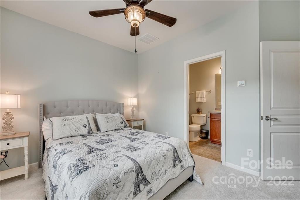 927 Lyndley Drive Fort Mill, SC 29708 - Photo 25 of 48 a bedroom with a bed and a chandelier