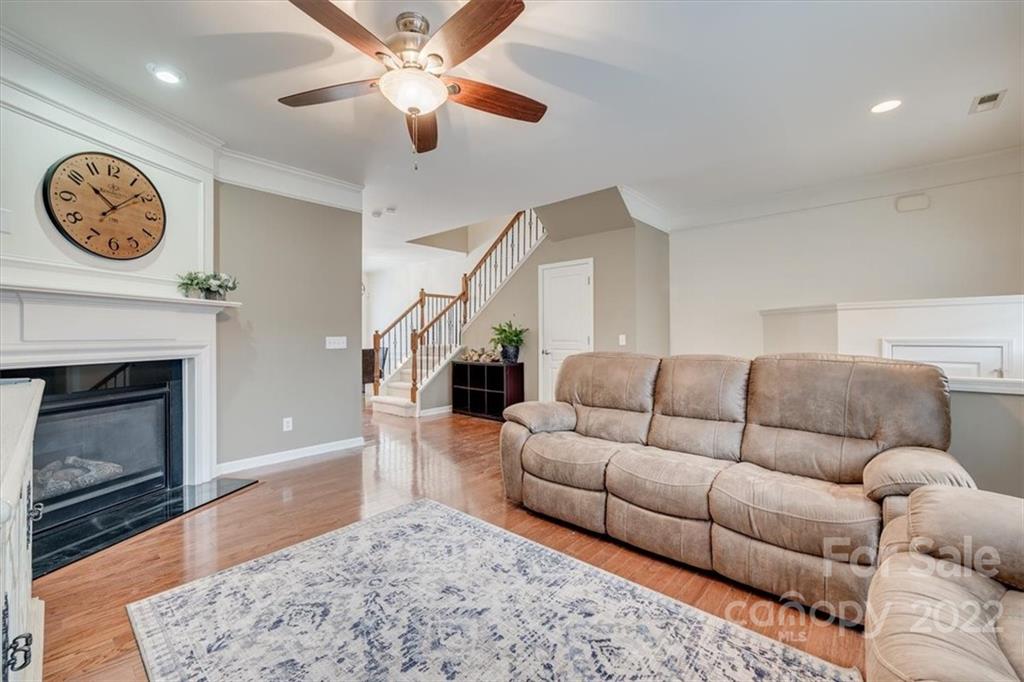 927 Lyndley Drive Fort Mill, SC 29708 - Photo 6 of 48 a living room with furniture a clock and a fireplace
