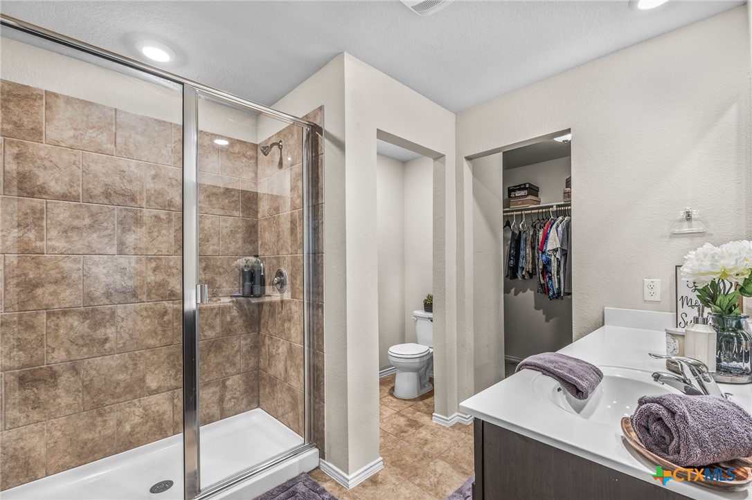 1006 Rosa Parks Drive Killeen, TX 76543 - Photo 16 of 34 a bathroom with a granite countertop sink a mirror and a shower