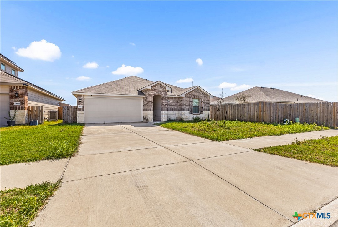 1006 Rosa Parks Drive Killeen, TX 76543 - Photo 2 of 34 a front view of a house with a yard and garage