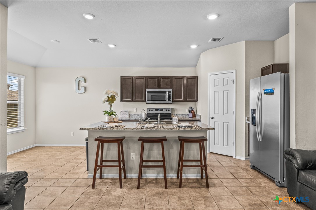 1006 Rosa Parks Drive Killeen, TX 76543 - Photo 8 of 34 a kitchen with stainless steel appliances granite countertop a sink a stove a refrigerator and a refrigerator