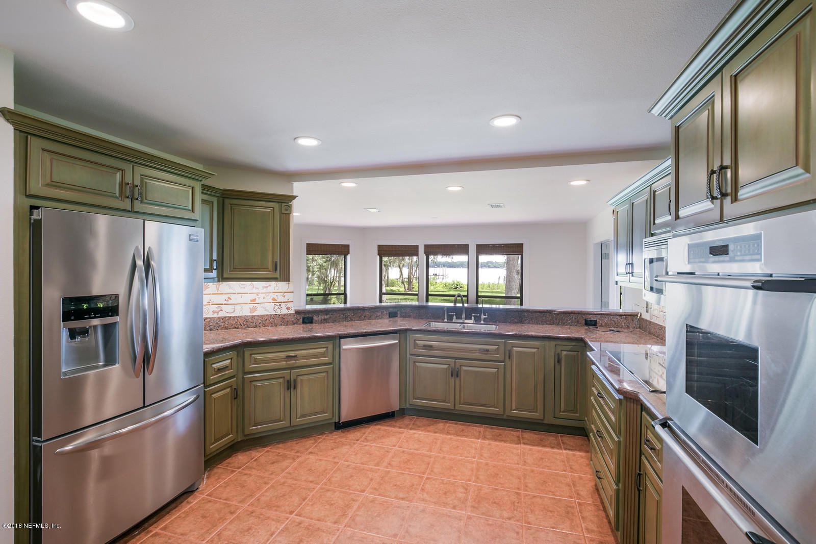 3130 Nautilus Road Middleburg, FL 32068 - Photo 12 of 67 a kitchen with stainless steel appliances granite countertop a refrigerator sink and microwave
