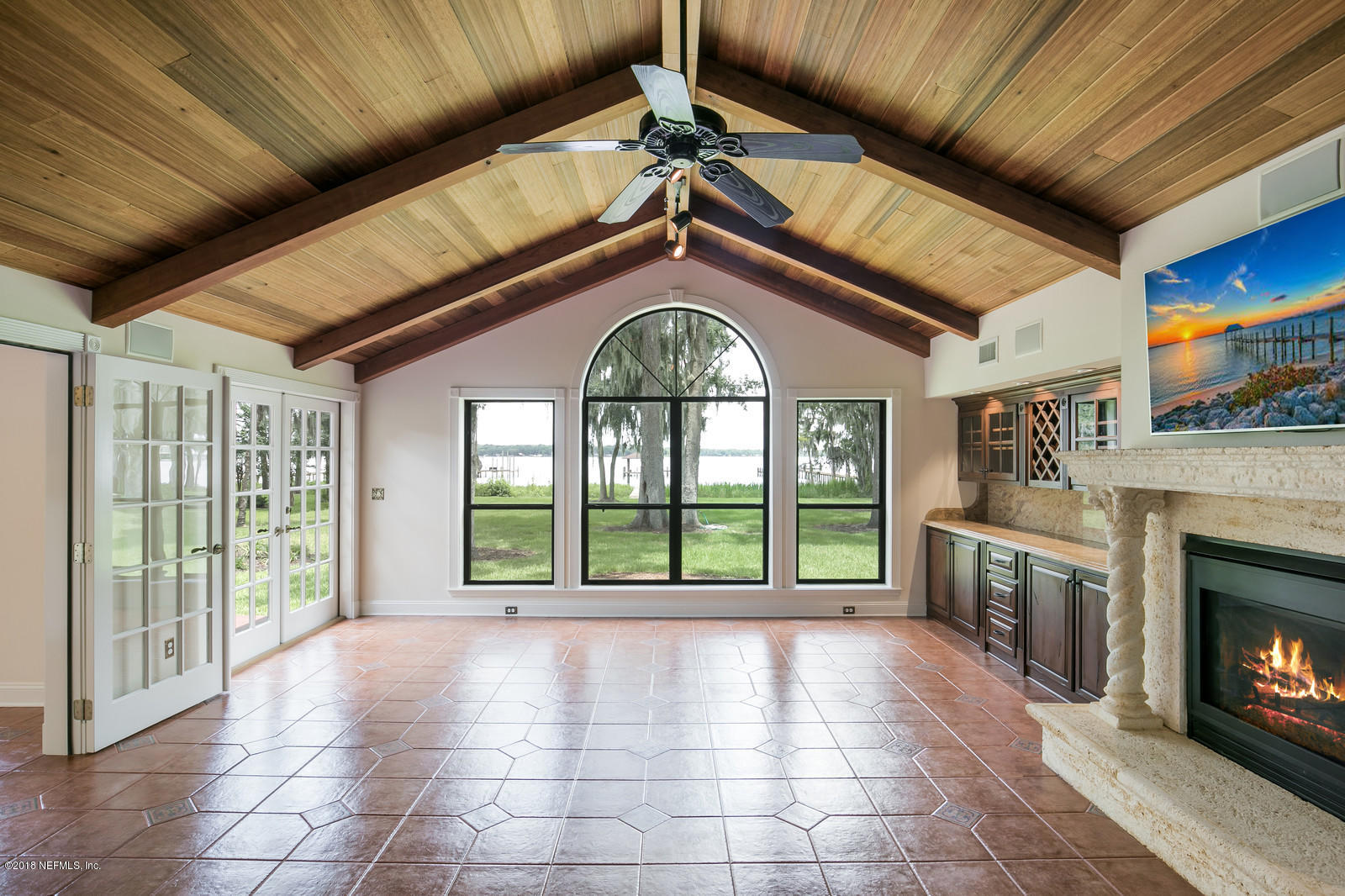 3130 Nautilus Road Middleburg, FL 32068 - Photo 23 of 67 a view of an empty room with a fireplace and a large window